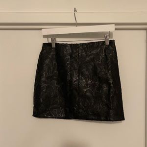 Black vegan leather mini skirt with sequin detail